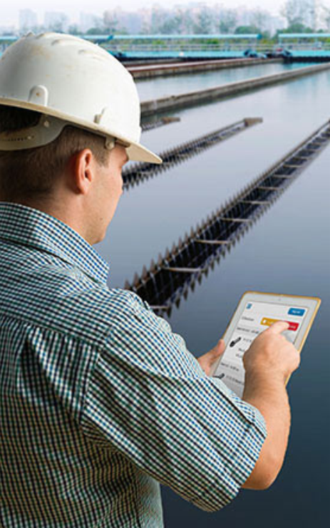 A person in a helmet using a tablet